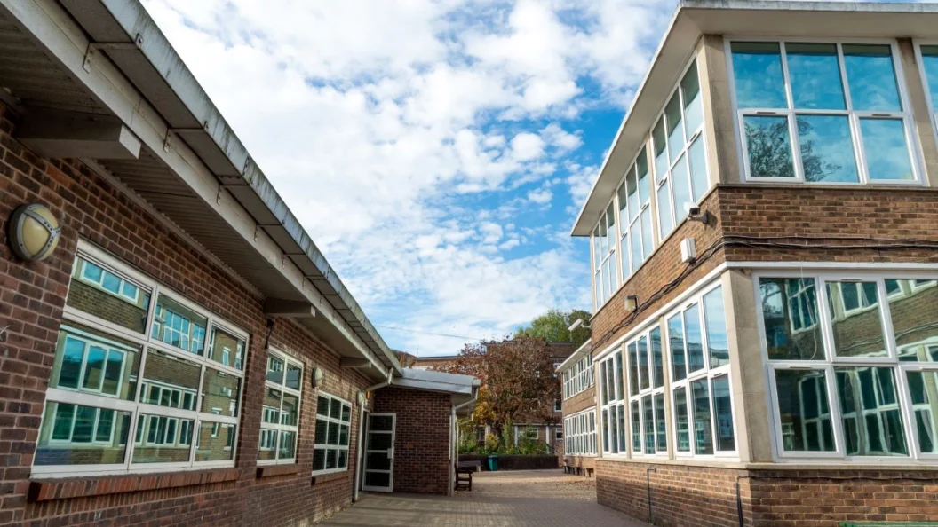 Clouds and blue sky over a school campus in England.