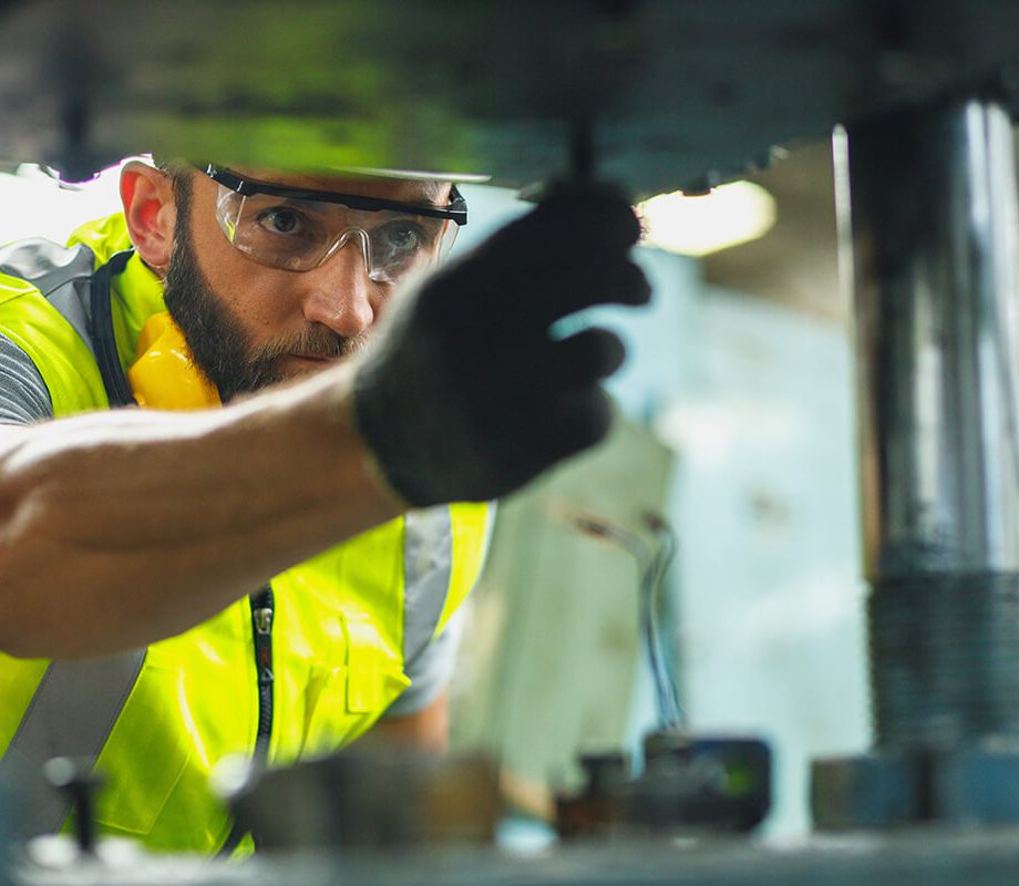 Man wearing PPE doing a safety inspection