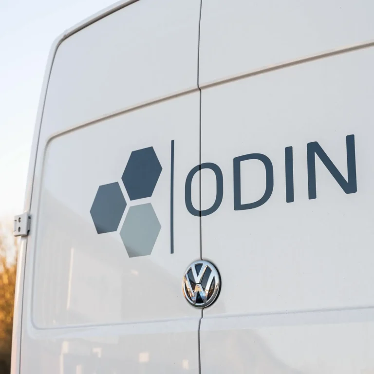 white van with the odin logo across the back doors